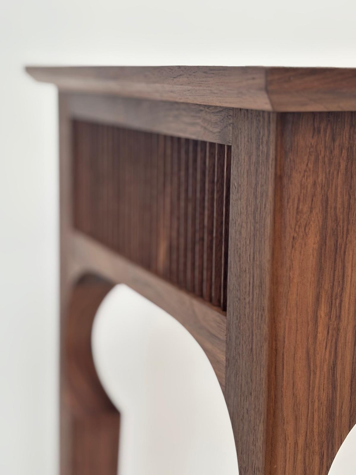 The Rhea — chamfered top edge with fluted apron and arched bracket